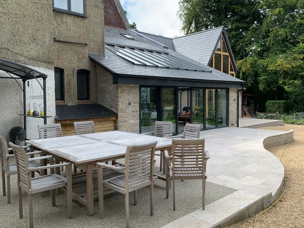 Stone extension with travertine patio and outdoor living space